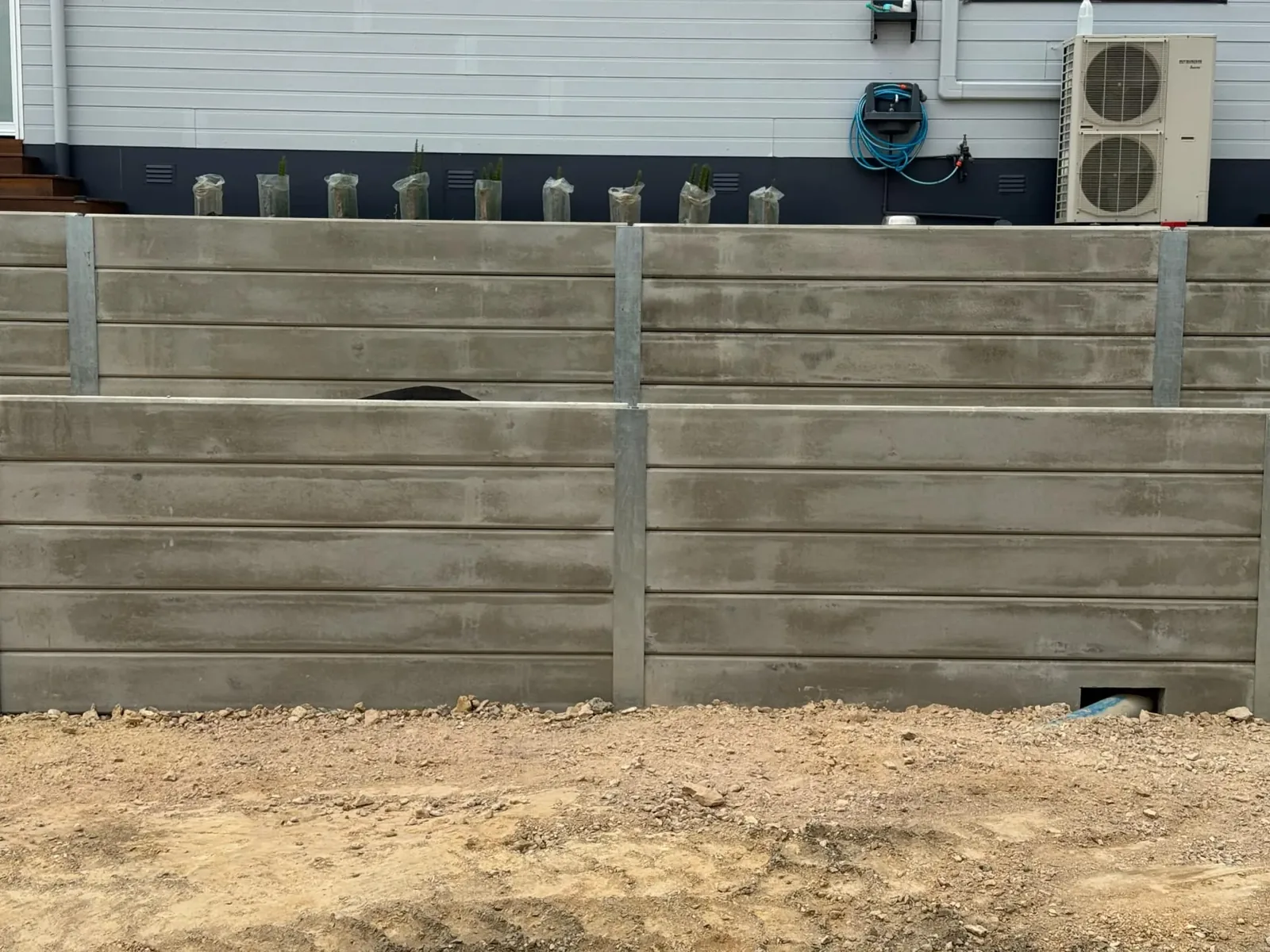 Concrete sleeper boundary retaining wall